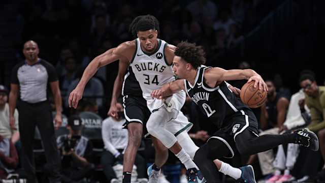 Brooklyn Nets forward Jalen Wilson (22) dribbles against Milwaukee Bucks forward Giannis Antetokounmpo (34) 